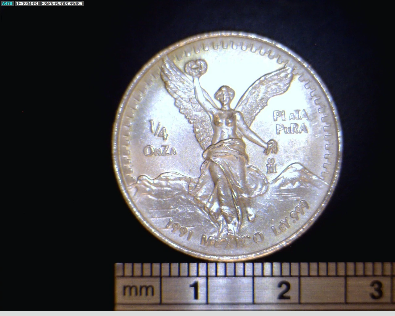 Reverse of a Mexican 1991 quarter-ounce silver Libertad showing Winged Victory, its fraction, date and .999 marking.