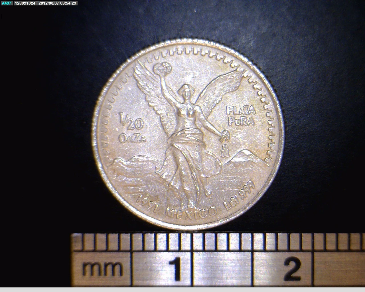 Reverse of a Mexican 1991 twentieth-ounce silver Libertad showing Winged Victory, its fraction, date and .999 marking.