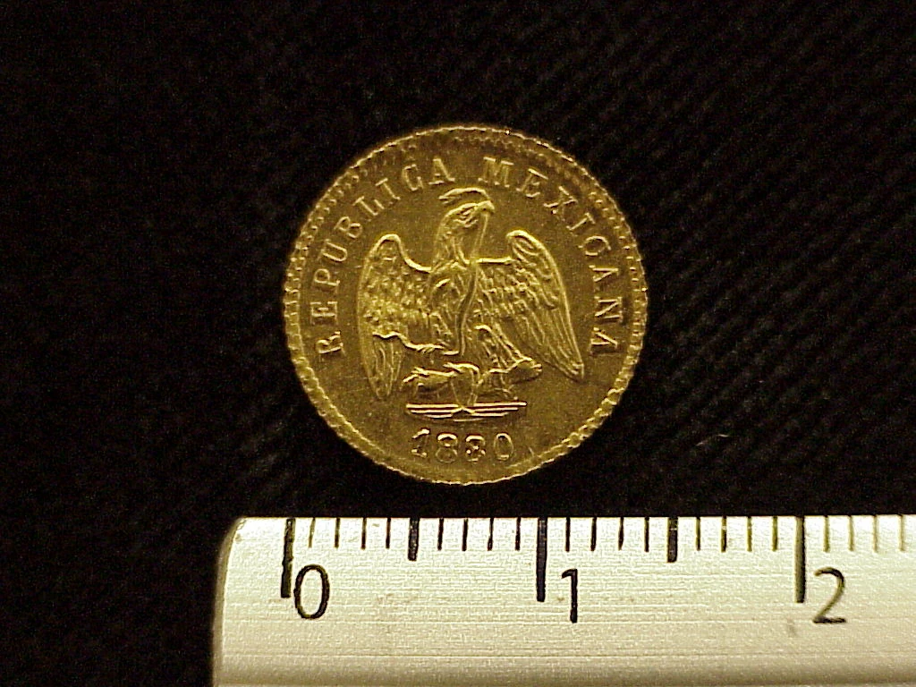 Obverse of a Mexican 1880 gold one peso coin showing the national eagle and date.