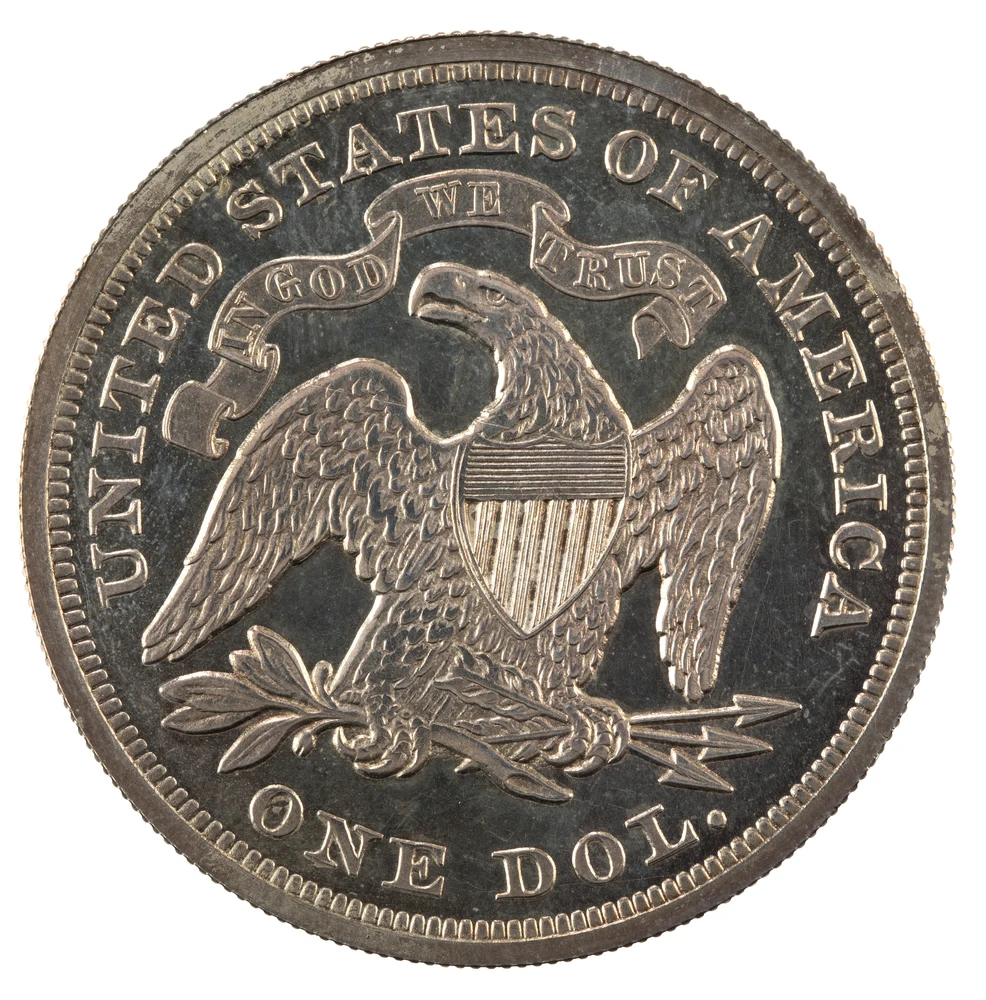 Liberty Seated Silver Dollar reverse — 1873 Philadelphia dollar with motto, genuine NNC specimen; both faces are illustrative, not a customer grading or authentication result.
