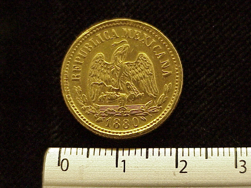 Obverse of a Mexican 1880 gold five pesos coin showing the national eagle and date.