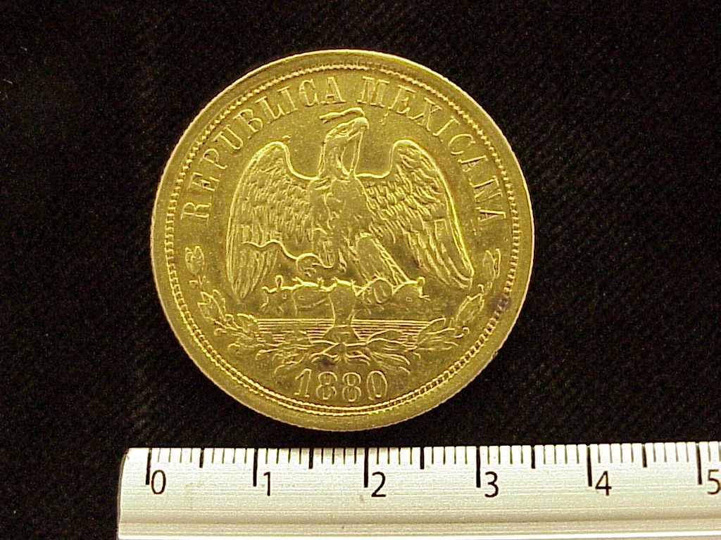 Obverse of a Mexican 1880 gold twenty pesos coin showing the national eagle and date.